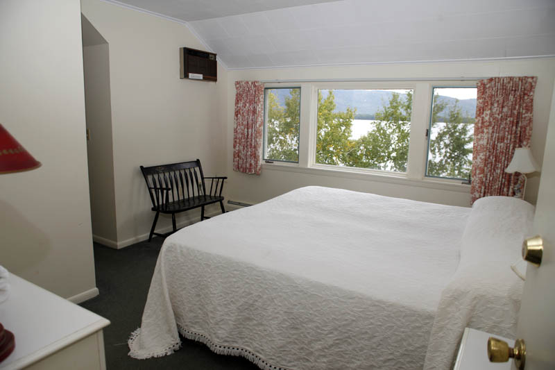 Upstairs bedroom with bed and views of lake george