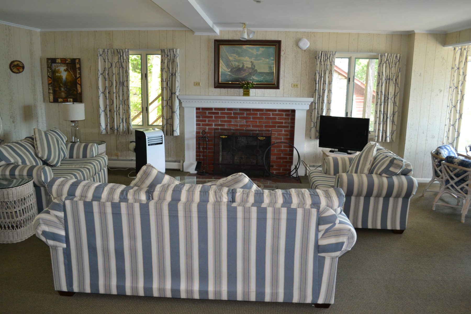 living room with blue striped couch and chairs